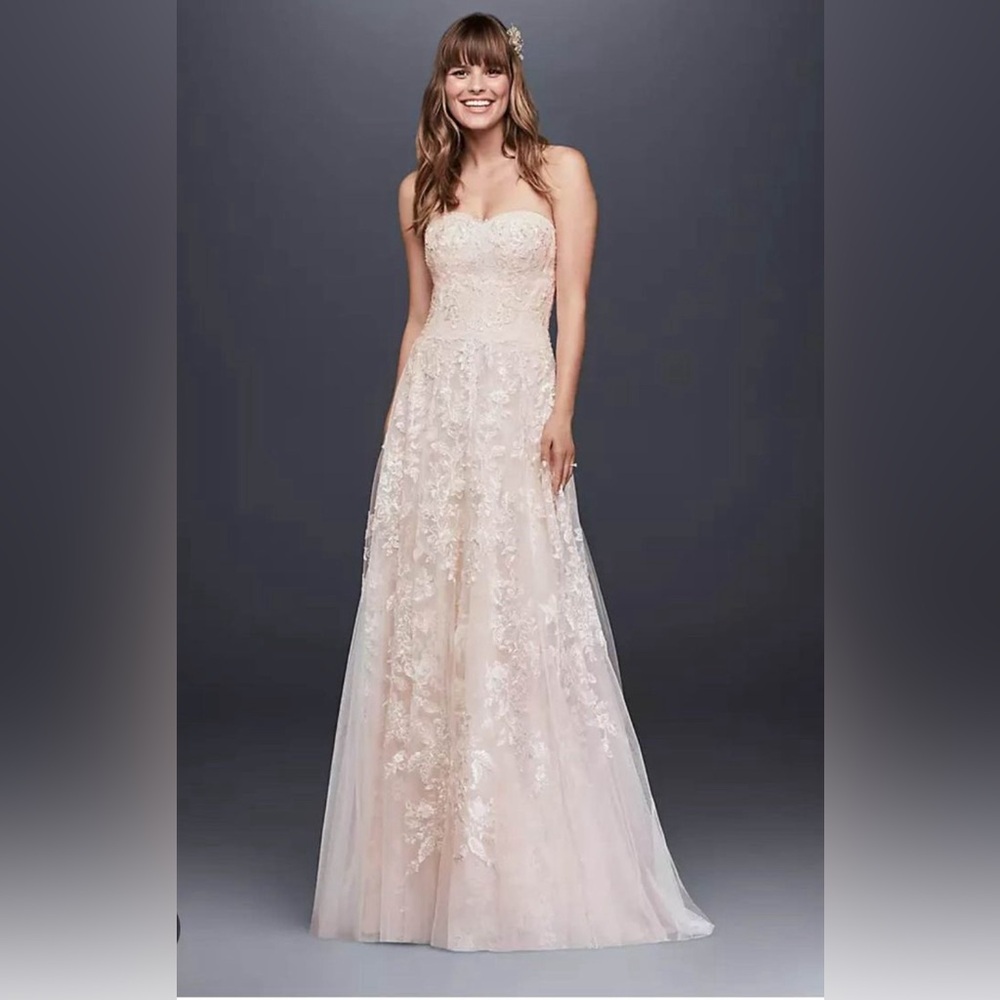 Brand new designer wedding dress w/ tags. $600French bustle & breast lift put in